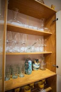 a shelf filled with glasses and other glass items at Piso 517 in San Fernando del Valle de Catamarca