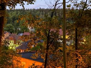 an autumn view of a town with trees and buildings at Polanica Luxury Apartment - Bliżej Zdroju in Polanica-Zdrój