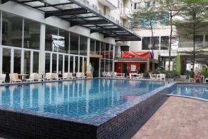 a large swimming pool in the middle of a building at Dejati Condotel Studio - Bogor Icon in Kedunghalang
