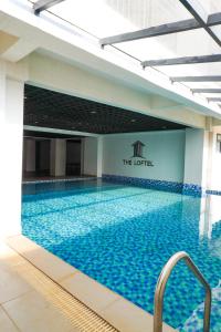a large swimming pool with a hotel sign on the wall at Ruaka apartment with a swimming pool in Nairobi