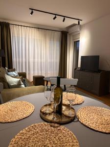 a living room with a table with wine glasses on it at A 207-Fruske Residence in Vrdnik