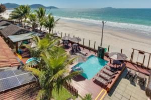 an overhead view of a swimming pool and the beach at Flat Pietra in Florianópolis