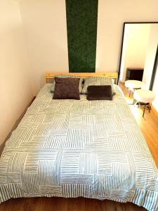 a bedroom with a large bed in a room at Escale - Maison - Nantes aéroport in Bouguenais +7 photos