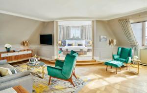 a living room with a bed and a couch at Mandarin Oriental, Munich in Munich