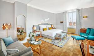 a bedroom with a bed and a living room at Mandarin Oriental, Munich in Munich
