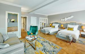 a bedroom with a bed and a living room at Mandarin Oriental, Munich in Munich