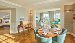 a dining room with a table and chairs at Mandarin Oriental, Munich in Munich