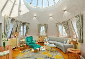 a living room with a couch and a table at Mandarin Oriental, Munich in Munich