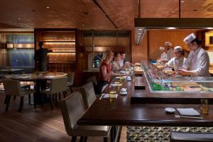 a group of chefs preparing food in a restaurant at Mandarin Oriental, Munich in Munich