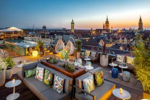 a rooftop bar with a view of the city at Mandarin Oriental, Munich in Munich