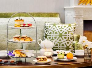 a table topped with plates of food and desserts at Mandarin Oriental, Munich in Munich