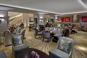 a hotel lobby with couches and chairs and tables at Mandarin Oriental, Munich in Munich