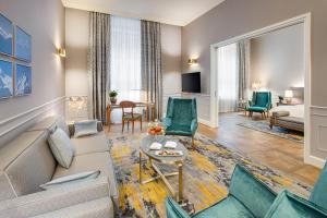 a living room with a couch and a table at Mandarin Oriental, Munich in Munich