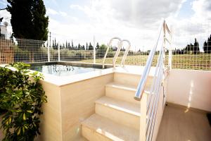 una vasca idromassaggio con scale e una piscina di La caseta de cinta a El Lligallo del Gànguil