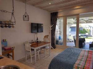 a bedroom with a bed and a table and chairs at Studio DE TUINKAMER Bed by the Sea in Westkapelle
