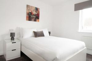 a white bedroom with a white bed and a window at The Voyager - Newly Furnished Home in Derby