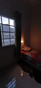 a bedroom with a window and a bed in a room at 228Hostel in Al Ḩamrāʼ