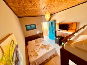 a bedroom with a bed and a blue door at LagoinhaKitePoint in Paraipaba