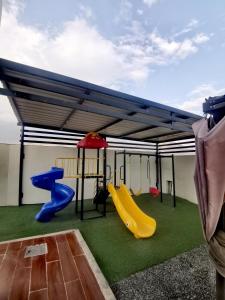 a play area with two slides and a playground at Highness Villa Nizwa in Nizwa