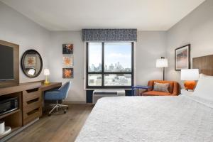 a hotel room with a bed and a desk and a window at Hampton by Hilton East Austin - near UT and Capitol in Austin +37 photos