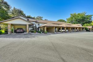 a building with a truck parked in the driveway at Heated Pool Citrus Hills Condo Near Golfing! in Hernando