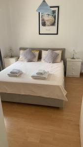 a bedroom with a large bed with two night stands at Gorgeous SeaView house in Pissouri