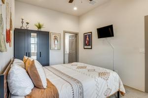 a bedroom with a bed and a flat screen tv at Private Patio Townhome By University of Arizona! in Tucson