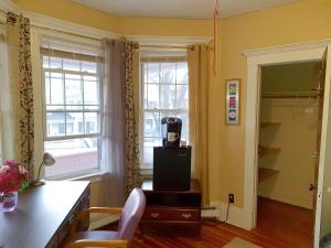 a living room with a television sitting on a table at West End Haven in Hartford