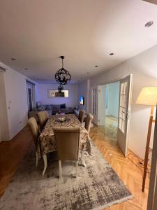 a dining room with a table and a couch at Luxury 2 Apartment in Bijelo Polje