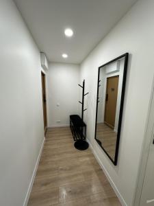 a hallway with a mirror on the wall at Moncerat in Šiauliai