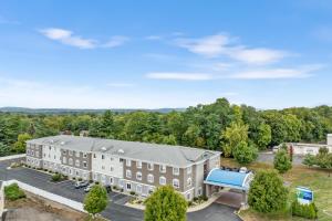 an aerial view of a building with a blue roof at Holiday Inn Express Hartford-Newington by IHG in Newington