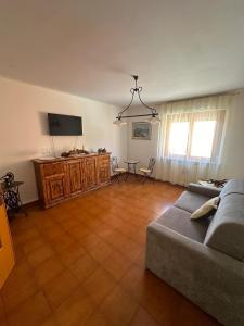a living room with a couch and a flat screen tv at Casa Vacanze Diva in Rosignano Solvay