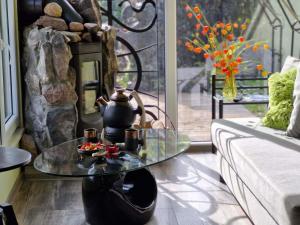 a living room with a coffee table and a couch at Ezerdzirnas in Celmenieki