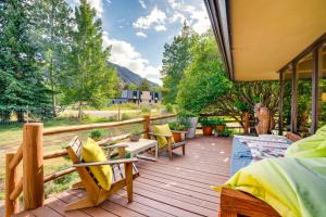 a wooden deck with chairs and tables on it at Mtn-View Frisco Home Near Skiing and Hiking! in Frisco