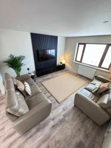 a living room with two couches and a flat screen tv at No 67 West Road in Fraserburgh
