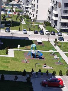 a view of a park with a playground and cars at Cozy Studio in Târgu-Mureş