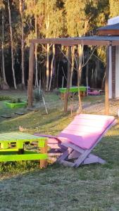 a pink picnic table and a picnic shelter in a park at Cabañas MyG in Tandil +16 photos