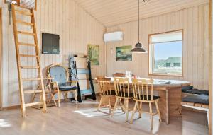 a dining room with a wooden table and chairs at Nice Home In Harboøre With Kitchen in Harboør