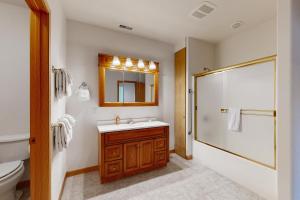 a bathroom with a sink and a shower at Sunnyside Retreat in Kalispell +42 photos