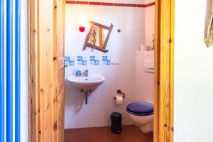 a bathroom with a toilet and a sink at Ginster in Zingst