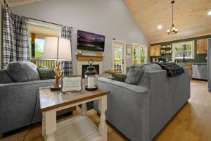 a living room with two couches and a table at Lazy Bear in Sevierville