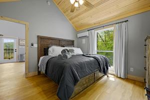 a bedroom with a bed and a large window at Lazy Bear in Sevierville