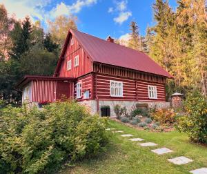 a red barn with a red roof at Chalupa Janovice in Rudník