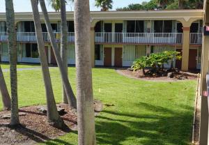 a building with palm trees in front of it at ISLAND HOTEL of Space Coast in Merritt Island