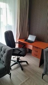 a desk with a laptop computer on top of it at Bela Getaway Homes Elegant One bedroom Apartment in Nairobi +10 photos