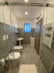 a bathroom with a shower and a toilet and a sink at GuestHouse Affittacamere Padre Pio MORCONE CENTRO in Morcone +11 photos