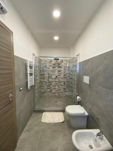 a bathroom with a shower and a toilet and a sink at GuestHouse Affittacamere Padre Pio MORCONE CENTRO in Morcone