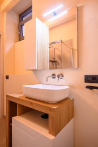 a bathroom with a white sink and a mirror at Casale Bellavista 1853, Cremia, Lago di Como in Cremia