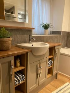 a bathroom with a sink and a mirror at Wynnstay Apartment, Harbour and Mountain Views in Barmouth +27 photos