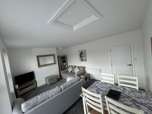 a living room with a couch and a television at 31a locking road in Weston-super-Mare